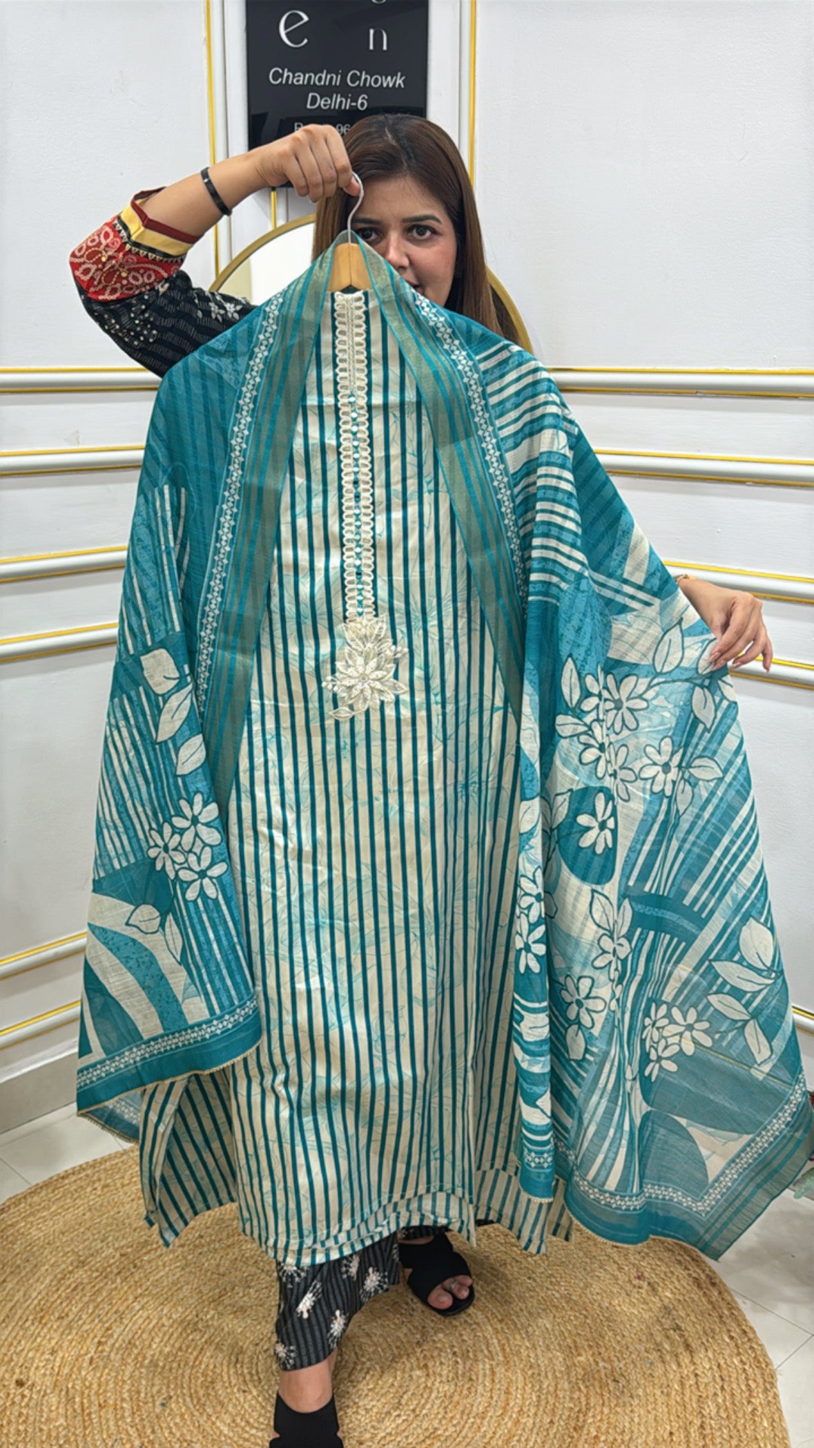 Model showcasing a premium cotton shirt with pearl details in blue floral pattern and intricate design